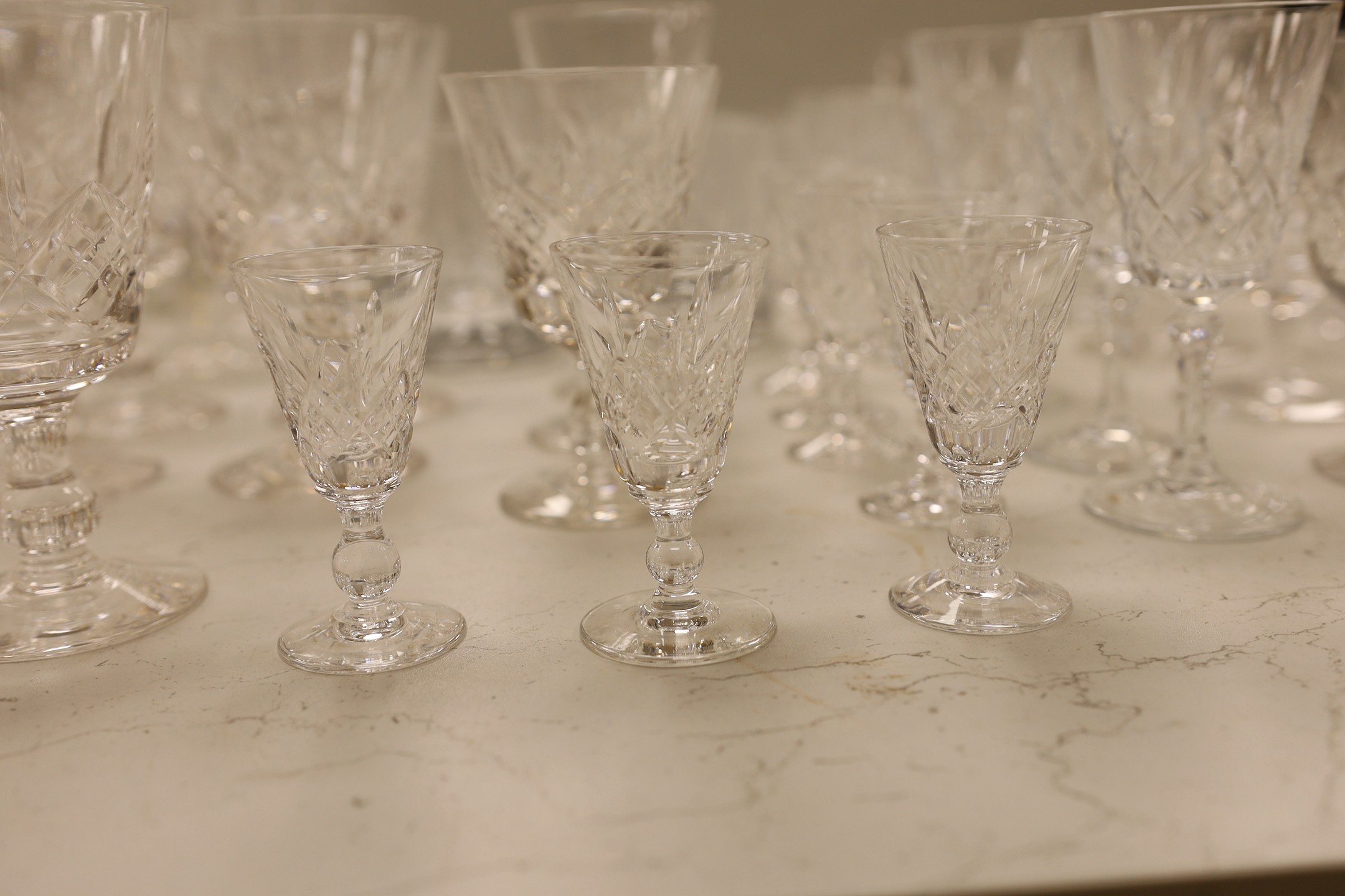 A large collection of suites of mostly Stuart cut glass, including, wine glasses, spirits glasses and jugs